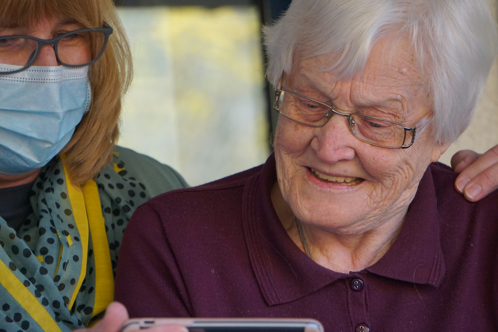 A caregiver sharing a moment with an elderly client at home